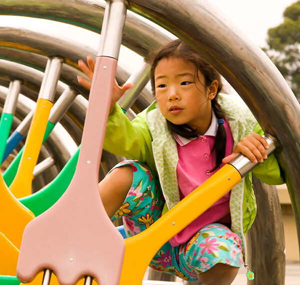A child climbing on the DNA sculpture exhibit at The Lawrence