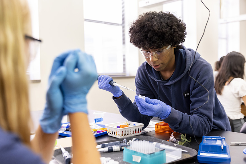 A Teen Research Program participant practicing using a pipette