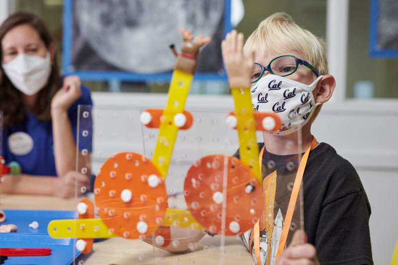 A student builds a mechanical linkage during the Linkages and Moving Toys workshop